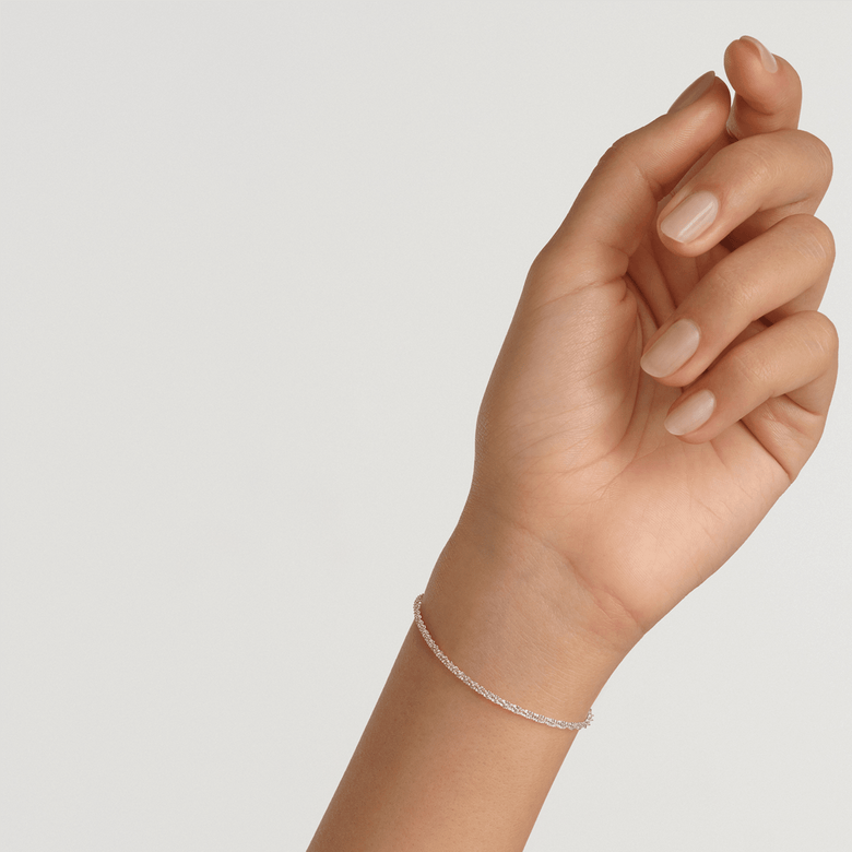 Twisted Chain Bracelet S in silver, worn on a wrist, showing its slim, textured chain and delicate styling suitable for everyday wear or layering with other jewellery.