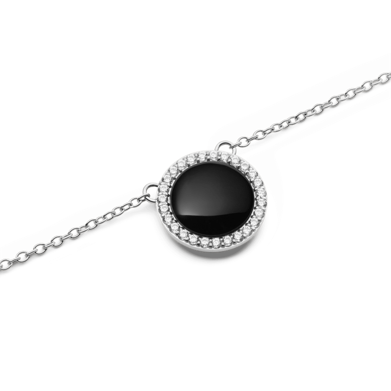 Close-up of the Audrey Necklace Black Agathe Silver, featuring a domed black agate pendant encircled by white cubic zirconia crystals on a polished silver chain.