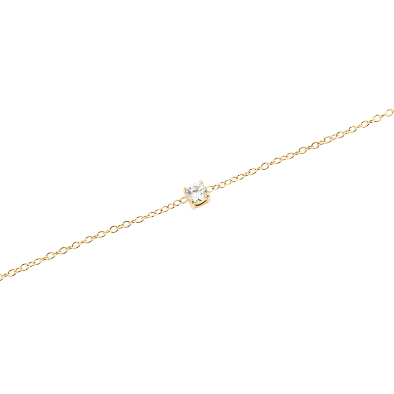Close-up of the Mirelle Solitaire Bracelet Gold, highlighting the fine gold chain and the single white cubic zirconia stone set in a minimalist style.