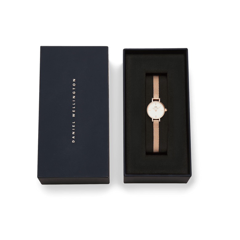 Petite Mini Melrose ladies watch with a rose gold mesh strap and minimalist white dial, elegantly presented in a branded Daniel Wellington gift box.