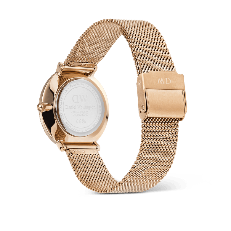 Back view of the Crystalline Bezel Melrose rose gold ladies watch, showing the stainless steel mesh strap with a secure clasp and the engraved case back.