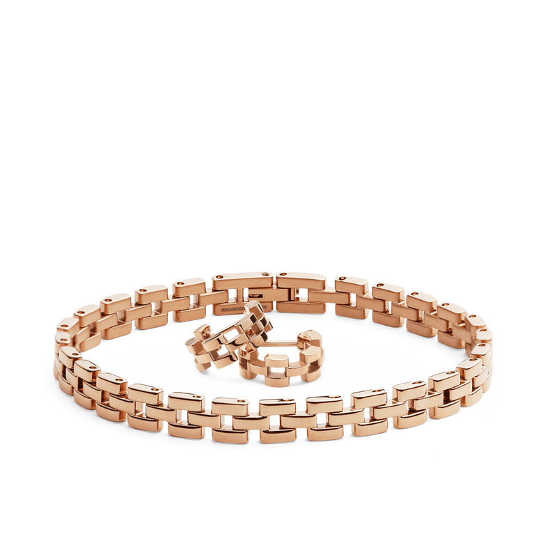 Rose gold jewellery set featuring a three-link chain bracelet and matching earrings, both with a polished, modern design and warm metallic finish.