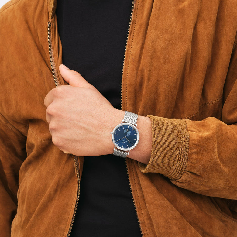 Classic Multi-Eye Sterling Arctic men's watch with a deep blue dial and silver mesh strap, worn with a casual brown suede jacket and black shirt, showing its versatility for everyday style.