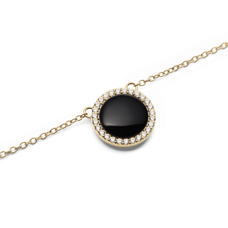 Close-up of the Audrey Necklace Black Agathe Gold showing a domed black agate pendant surrounded by a halo of white cubic zirconia crystals on a fine gold chain.
