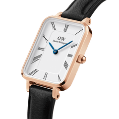 Quadro Roman Numerals Sheffield Rose Gold ladies watch featuring a rectangular rose gold case, crisp white dial with Roman numerals, blue steel hands, and a slim black leather strap.