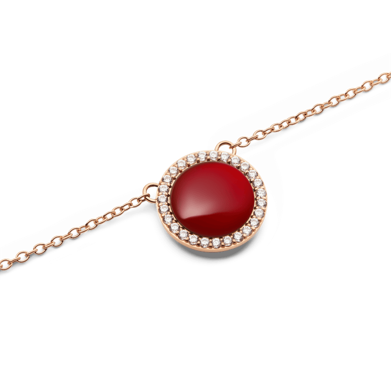 Close-up of the Audrey Necklace Red Agathe Rose Gold pendant, showcasing a domed red agate stone encircled by white cubic zirconia crystals on a fine rose gold chain.