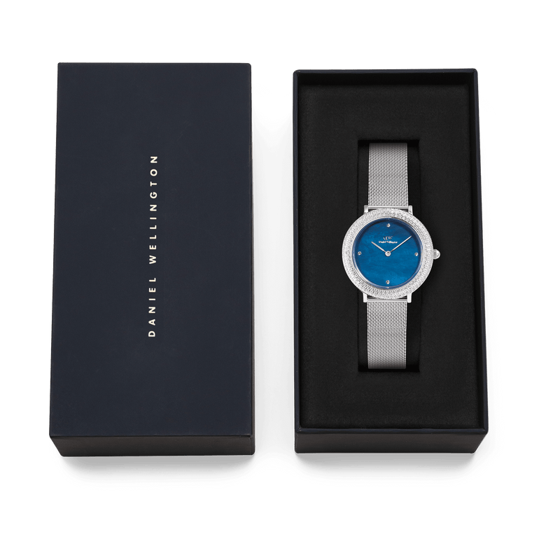 Daniel Wellington Crystalline Bezel Sterling Blue ladies watch with a blue mother of pearl dial and silver mesh strap, presented in a branded gift box.