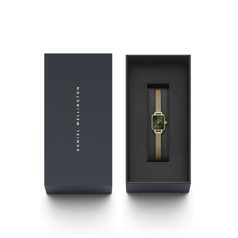 Quadro Mini Evergold Emerald gold watch with emerald green dial and mesh strap, elegantly presented in a Daniel Wellington branded gift box.