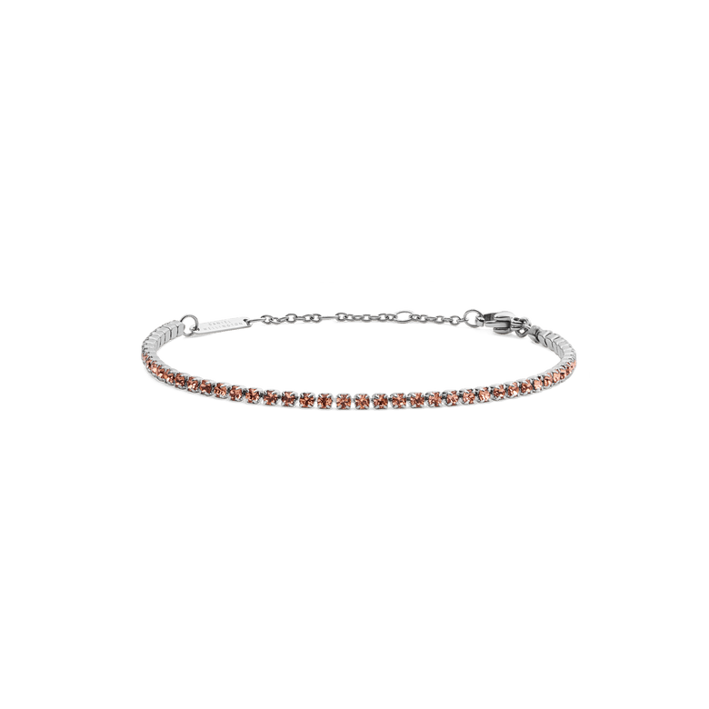 A slim silver tennis bracelet featuring apricot-coloured crystals set along a delicate chain, with an adjustable clasp for a comfortable fit.