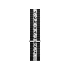 Black and white NATO strap by Daniel Wellington featuring Steven Harrington’s graphic eye-print design, crafted from durable polyester fabric with a silver clasp and adjustable fit.