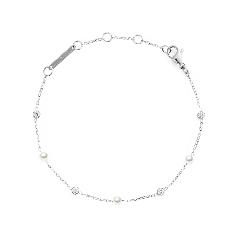 Delicate silver bracelet featuring alternating white Swarovski glass pearls and cubic zirconia on a slim chain, with adjustable links and a secure clasp for a comfortable fit.
