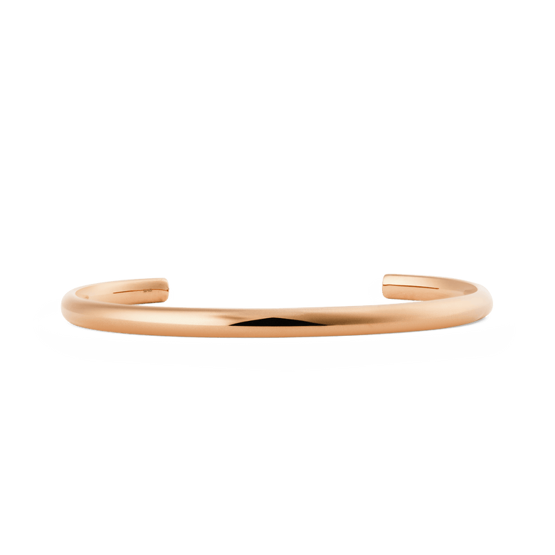 Slim rose gold cuff bracelet with a softly rounded, minimalist design and a polished finish, featuring an open-ended adjustable style suitable for everyday wear.