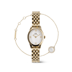 Gold Daniel Wellington Ophelia Mini watch with a white oval dial and Roman numerals, paired with the Audrey Gold bracelet featuring a fine chain and a round mother-of-pearl charm bordered by sparkling stones.