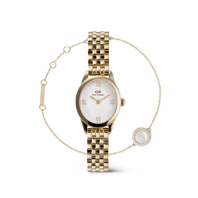 Gold Daniel Wellington Ophelia Mini watch with a white oval dial and Roman numerals, paired with the Audrey Gold bracelet featuring a fine chain and a round mother-of-pearl charm bordered by sparkling stones.