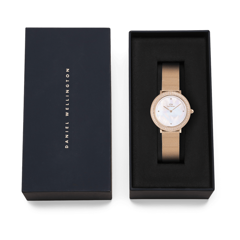 Crystalline Bezel Melrose rose gold ladies watch with a crystal-set bezel and mesh strap, elegantly presented in a black Daniel Wellington gift box.