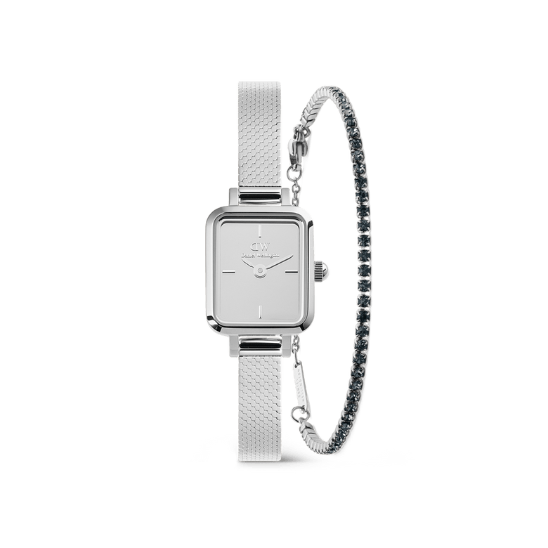 Rectangular silver Daniel Wellington Quadro Reflection watch with a slim mesh strap, paired with a Classic Tennis Bracelet featuring sparkling stones and a delicate profile, both designed for women seeking elegant and contemporary style.