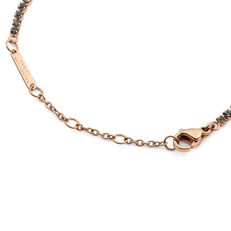 Detail view of the Classic Tennis Bracelet Nightfall Rose Gold showing the rose gold lobster clasp, adjustable sizing rings, and individually set dark Preciosa crystals for a secure and elegant finish.