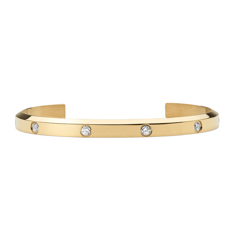 Slim gold cuff bracelet with a polished finish, featuring eight evenly spaced cubic zirconia stones set along the band for a refined and elegant look.