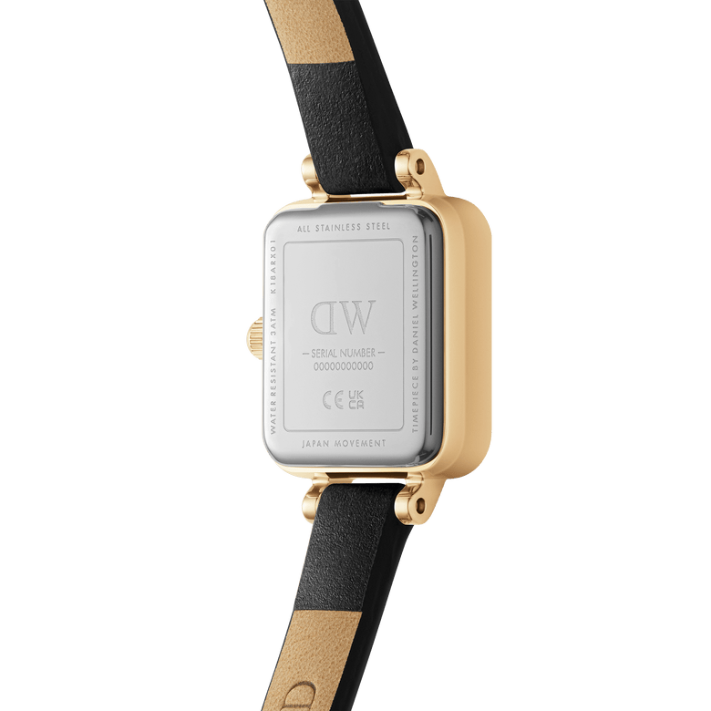 Rear view of the Quadro Mini Sheffield Gold watch showing its stainless steel case back, gold-tone edges, and genuine black leather strap with beige lining.