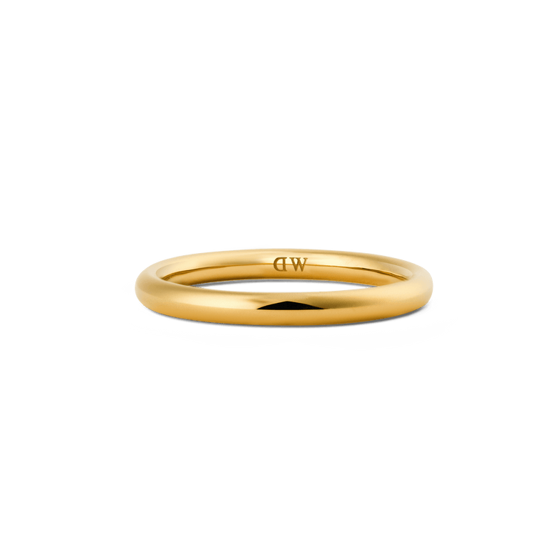 A slim, rounded gold ring with a high-polish finish, featuring a discreet inner logo and a minimalist design suitable for stacking or wearing alone.