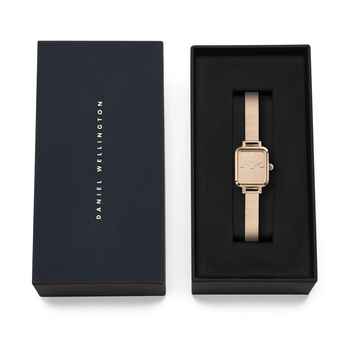 Quadro Mini Reflection Rose Gold ladies watch with a slim rectangular case and rose gold mesh strap, presented in a black Daniel Wellington gift box.