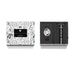 Daniel Wellington Bristol BW dial watch set from the Steven Harrington collaboration, featuring a silver watch with brown leather strap, an extra eye-print NATO strap, and packaging decorated with Steven Harrington’s signature black and white illustrations.