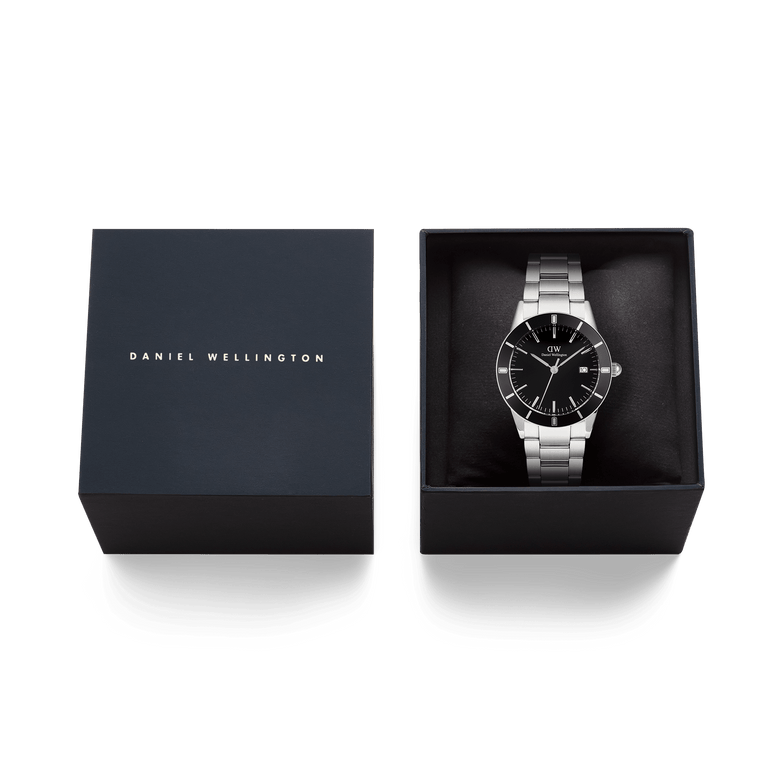 Iconic Paradigma Link Black Enamel watch with a silver stainless steel bracelet and black dial, elegantly presented in a Daniel Wellington gift box, ideal for gifting or adding to your collection.