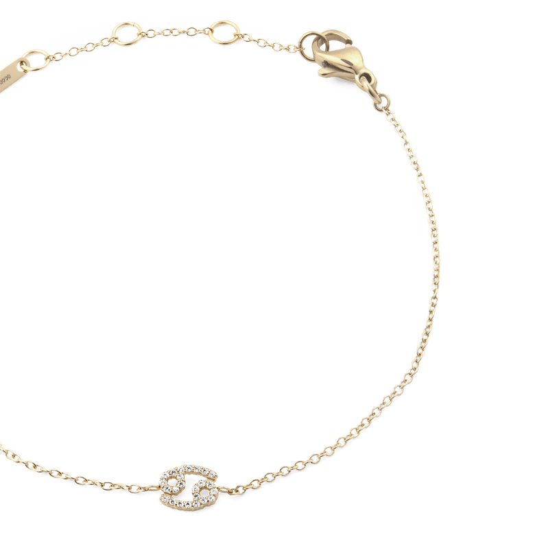 Gold chain bracelet with an adjustable clasp, featuring a Cancer zodiac charm set with sparkling crystals and a slim, elegant design.