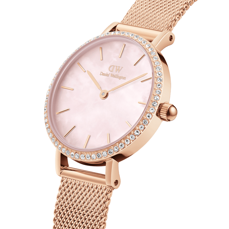 Close-up of the Petite Lumine Bezel Melrose Pink MOP ladies watch, showing its rose gold mesh strap, crystal-set bezel, and pink mother of pearl dial with minimalist hour markers.