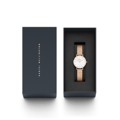 Petite Lumine Pressed Piano White MoP Rose Gold ladies watch with a white mother of pearl dial and rose gold pressed piano link strap, elegantly presented in a Daniel Wellington gift box.