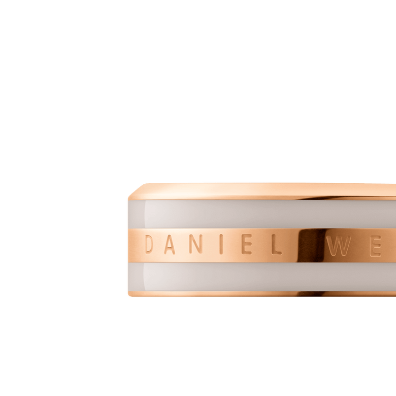Close-up of the Emalie Ring Desert Sand Rose Gold, showing the engraved Daniel Wellington logo on a polished rose gold band with a smooth desert sand enamel inlay.