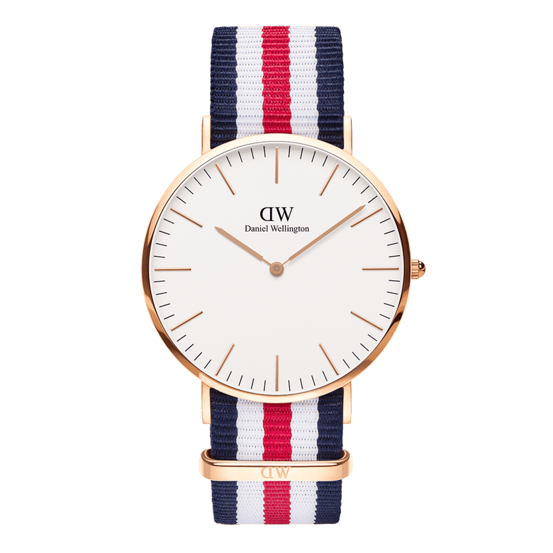 Classic Canterbury Rose Gold watch with a slim rose gold case, minimalist eggshell white dial, and a blue, white, and red striped NATO fabric strap. The design is modern and versatile, suitable for both men and women.