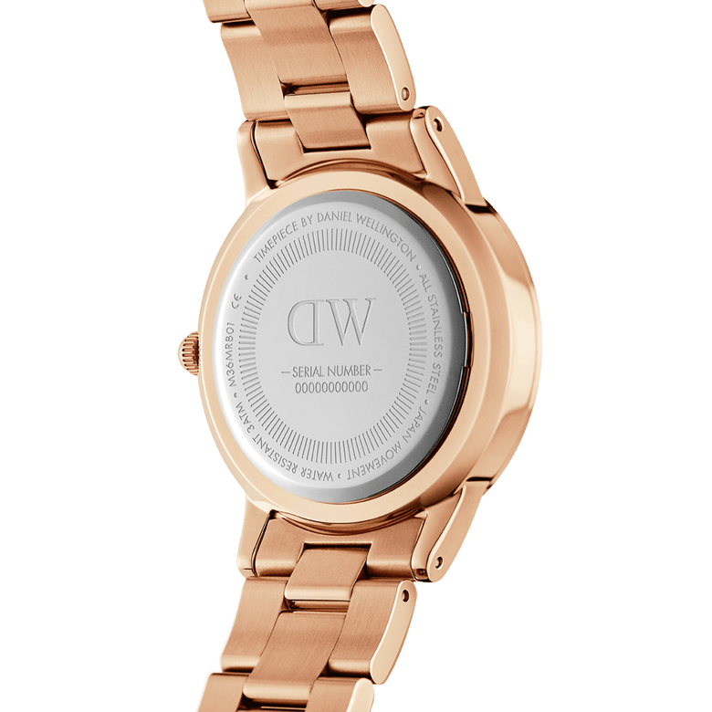 Back view of the Iconic Link Unitone RG rose gold ladies watch, showing the stainless steel case back, engraved details, and polished rose gold link bracelet.