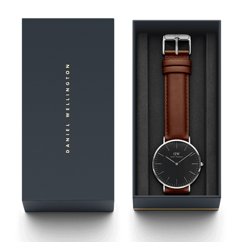 Classic St Mawes Black Silver watch with a black dial and brown leather strap, elegantly presented in a branded Daniel Wellington gift box.
