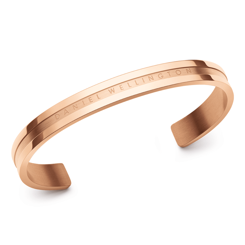 Elan Bracelet Rose Gold by Daniel Wellington with a minimalist open cuff design, polished rose gold finish, and engraved logo, crafted for a timeless and versatile look.