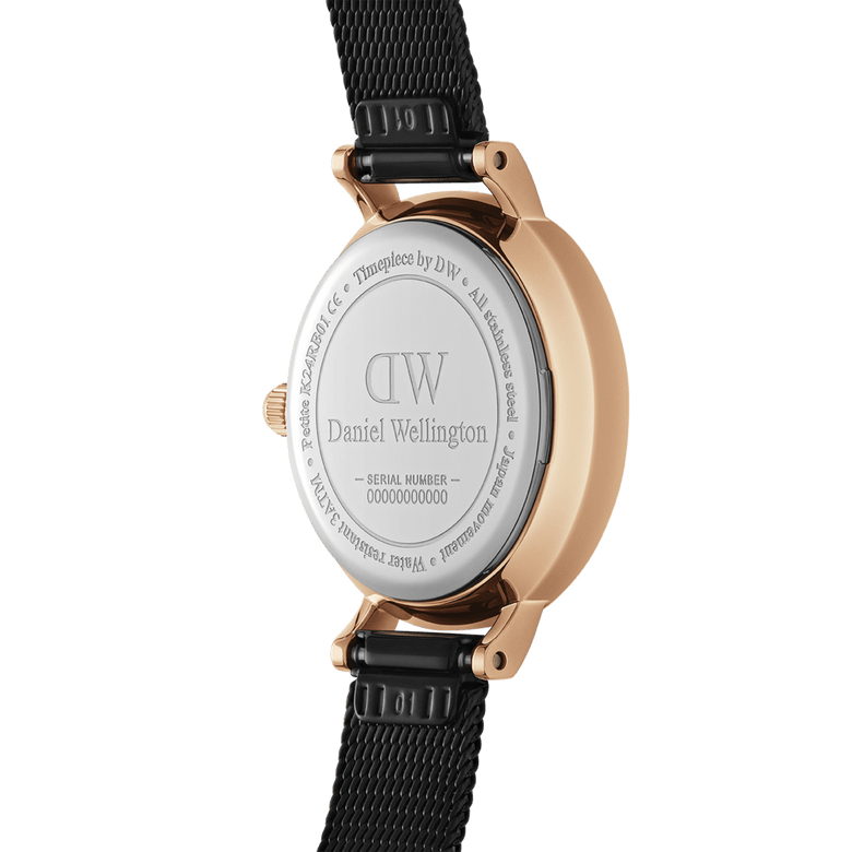 Close-up of the Petite Pressed Ashfield watch showing the engraved stainless steel case back, rose gold plating, and adjustable black mesh strap.