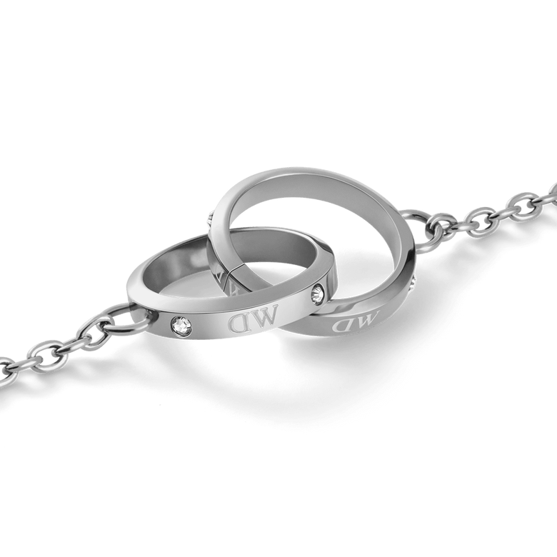 Close-up of the Classic Lumine Unity Silver necklace pendant, featuring two interlocking polished silver rings with subtle crystal accents on a fine chain, crafted from stainless steel for a modern, elegant look.