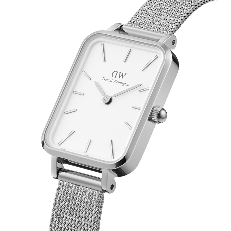 Quadro Pressed Sterling showcases a close-up of its rectangular stainless steel case, eggshell white dial, and pressed silver mesh strap, highlighting its minimalist and refined design for women.