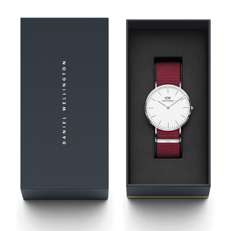 Classic Roselyn Silver watch with a ruby red NATO strap, eggshell white dial, and minimalist silver case, presented in a sleek Daniel Wellington gift box.