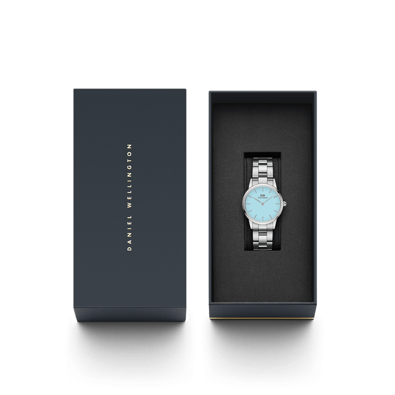 Iconic Link Capri women’s watch with a silver stainless steel bracelet and pastel blue dial, elegantly presented in a branded Daniel Wellington gift box.