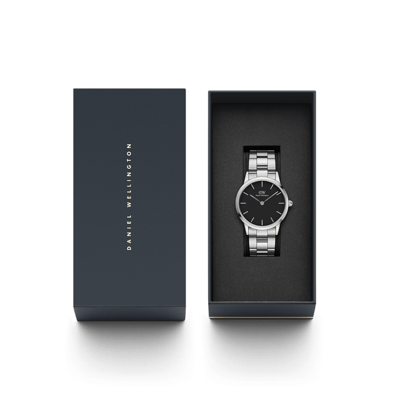 The Iconic Link watch by Daniel Wellington is presented in an elegant gift box, showcasing its polished stainless steel bracelet and minimalist black dial for a refined, modern look.