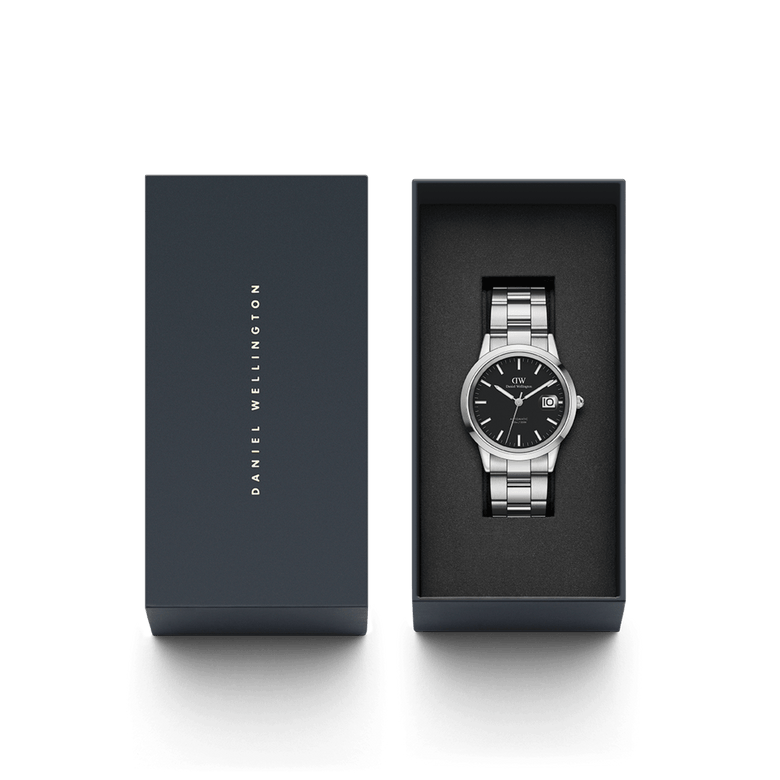 Daniel Wellington Iconic Link Automatic watch with a black dial and stainless steel bracelet, presented in an elegant branded gift box.