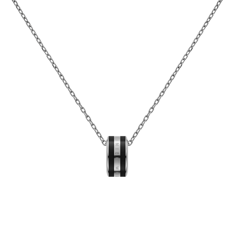 Close-up of the Emalie Necklace Silver Black showing a polished silver chain with a bold black enamel pendant, featuring engraved branding for a sleek and modern finish.