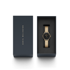 Petite Lumine Pressed Piano Black MoP Gold watch presented in a sleek Daniel Wellington gift box, featuring a gold mesh strap and a black mother of pearl dial with crystal markers.
