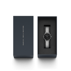 Petite Lumine Pressed Piano Black MoP Silver watch with a black mother of pearl dial and silver mesh-inspired strap, elegantly presented in a Daniel Wellington gift box.