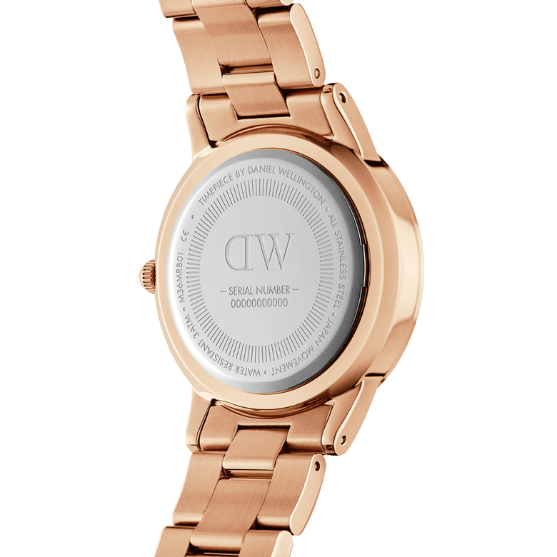 Back view of the Iconic Link Pink Rose Gold ladies watch, highlighting the engraved stainless steel case, rose gold link bracelet, and serial number detail.