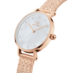 Petite Lumine Pressed Piano White MoP Rose Gold ladies watch featuring a white mother of pearl dial with crystal hour markers and a textured rose gold pressed piano link strap, shown in a close-up angled view.