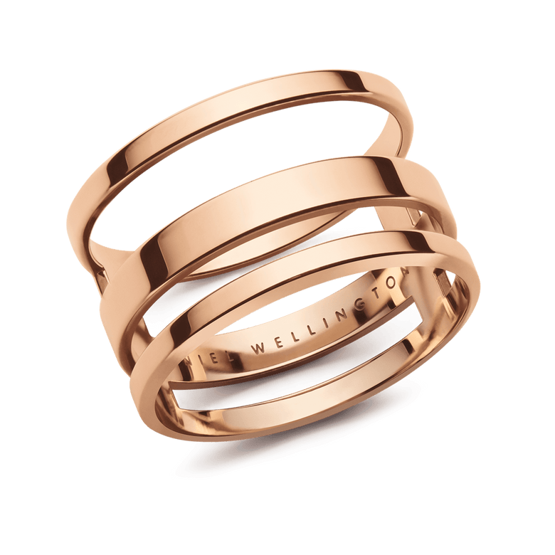 Triple band rose gold ring with a polished finish and open architectural design, crafted from stainless steel and engraved with Daniel Wellington on the inner band.