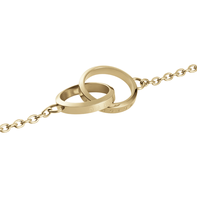 Close-up of the Elan Unity Bracelet pendant, showing two interlocking gold rings with engraved detailing and a delicate chain, crafted from stainless steel with a polished finish.