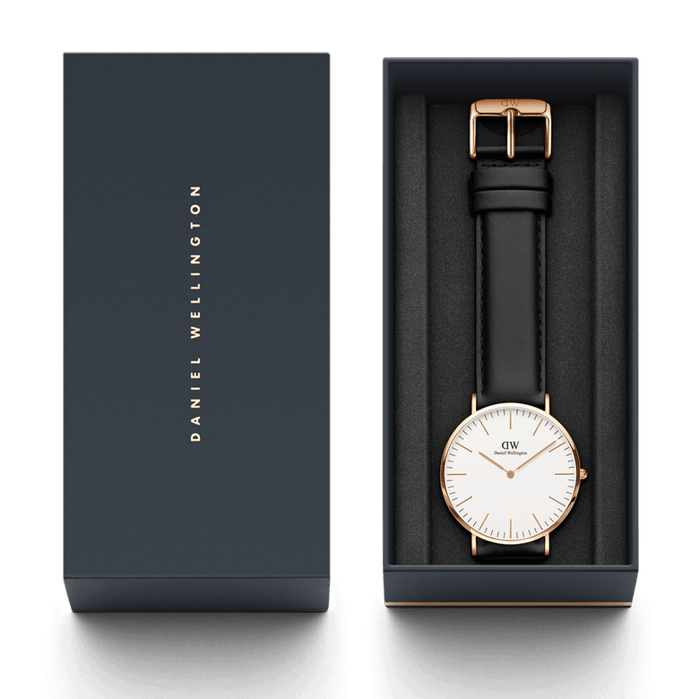 Classic Sheffield Rose Gold watch with a black leather strap and minimalist white dial, presented in an elegant Daniel Wellington gift box.